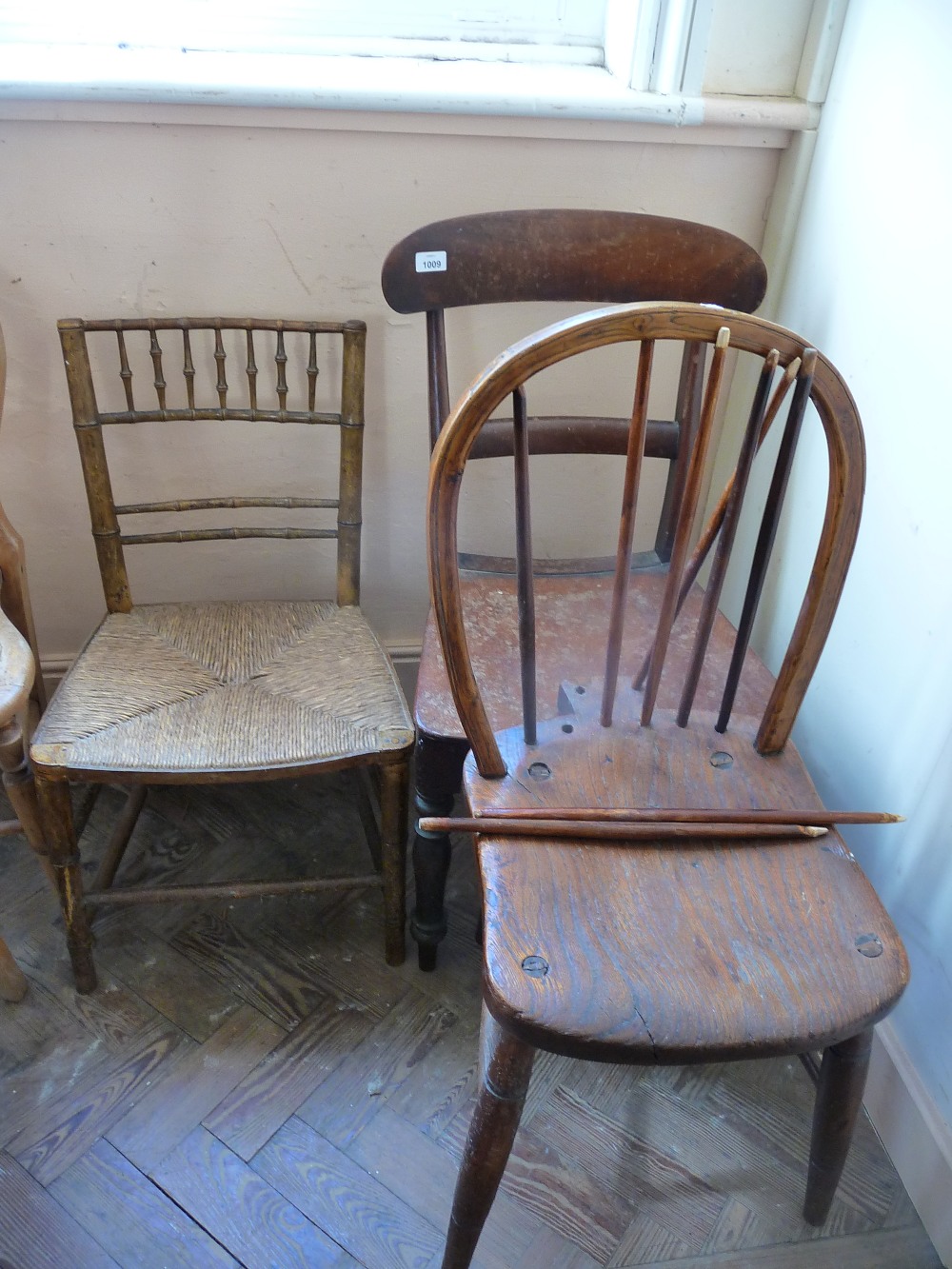 Two country chairs and one faux bamboo rush seated chair.