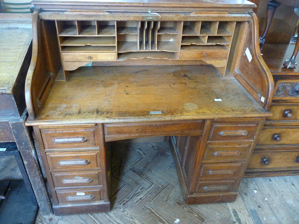 A tambour top nine drawer pedestal desk, D. 29", W. 49 1/2", H. to writing surface 32" and full H.