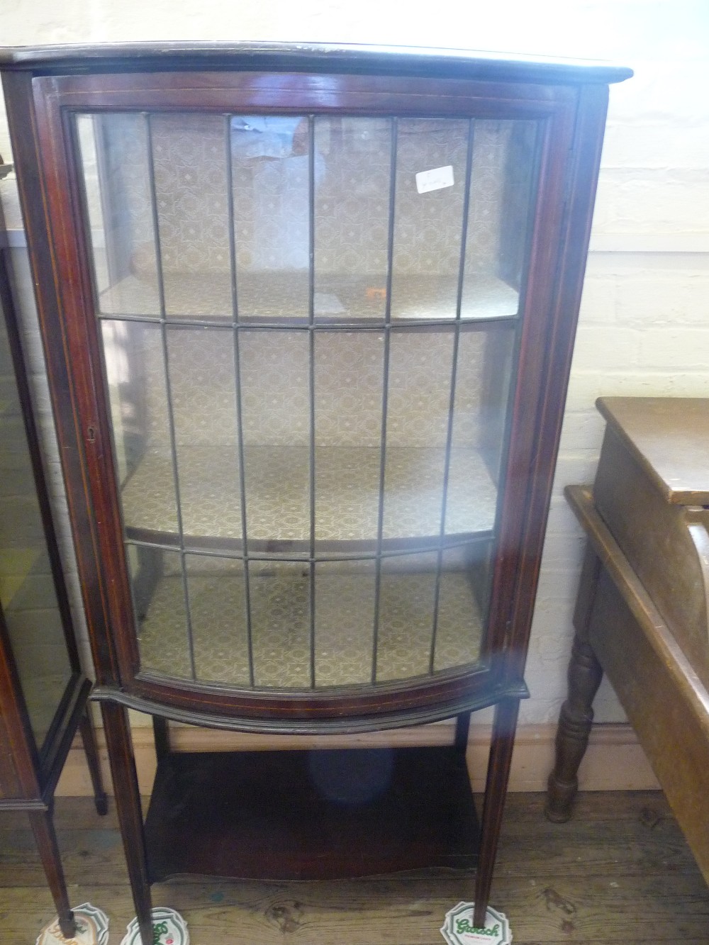 An Edwardian Mahogany inlaid bow fronted, lead glazed display cabinet and folding card table.