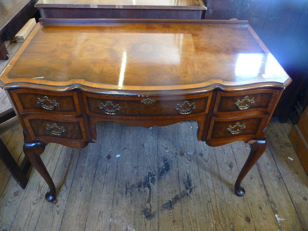 A Waring & Gillow Ltd, Lancaster, reproduction cross banded Walnut dressing table of five drawers on