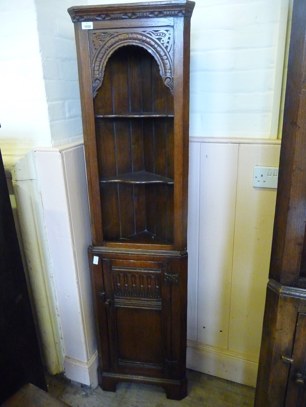 A small Oak carved floor standing corner display cabinet, D. 12", W. 17", H. 66".