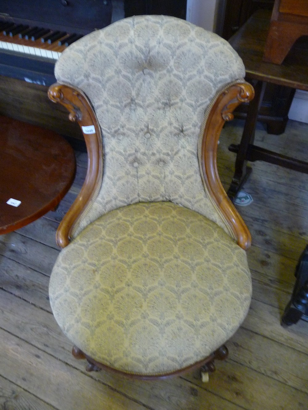 A Victorian button back low bedroom chair.