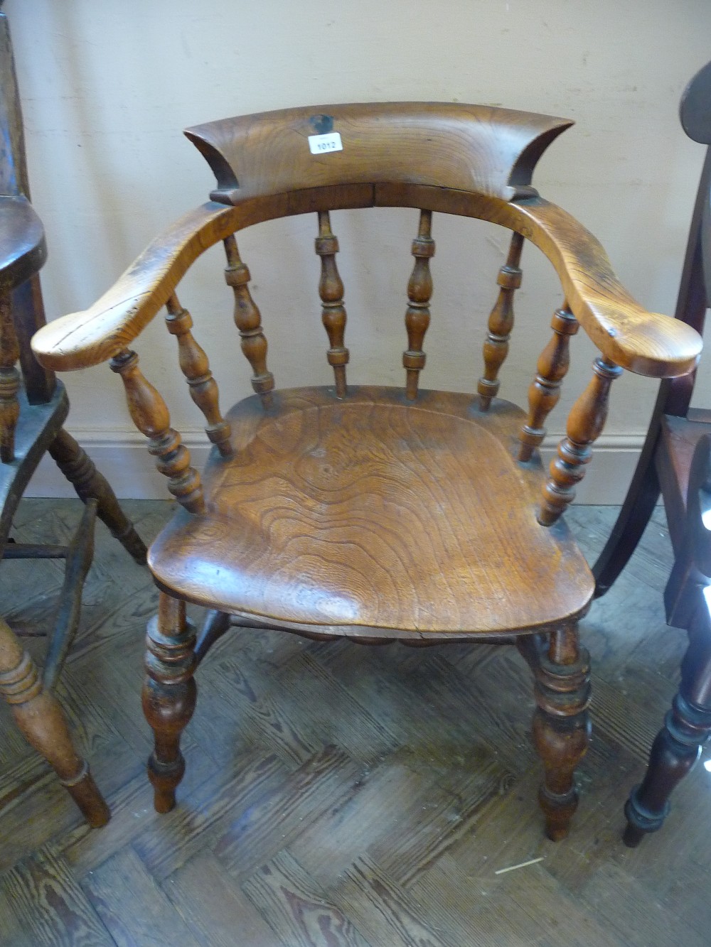 A spindle back captain`s chair with bobbin stretchers.
