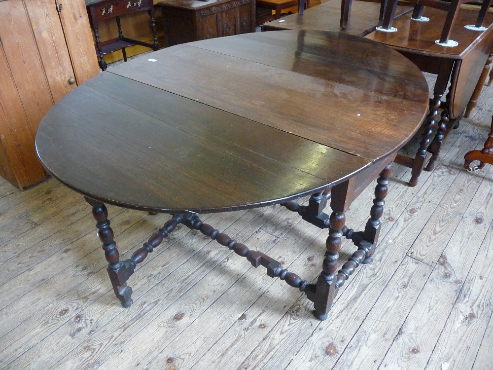 A George III circular gateleg table with bobbin supports and replacement drawer, D. 46 1/2" W.