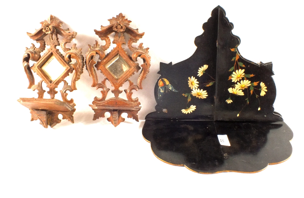 A Victorian papier mache floral and butterfly wall bracket and a small pair of mirrored wall