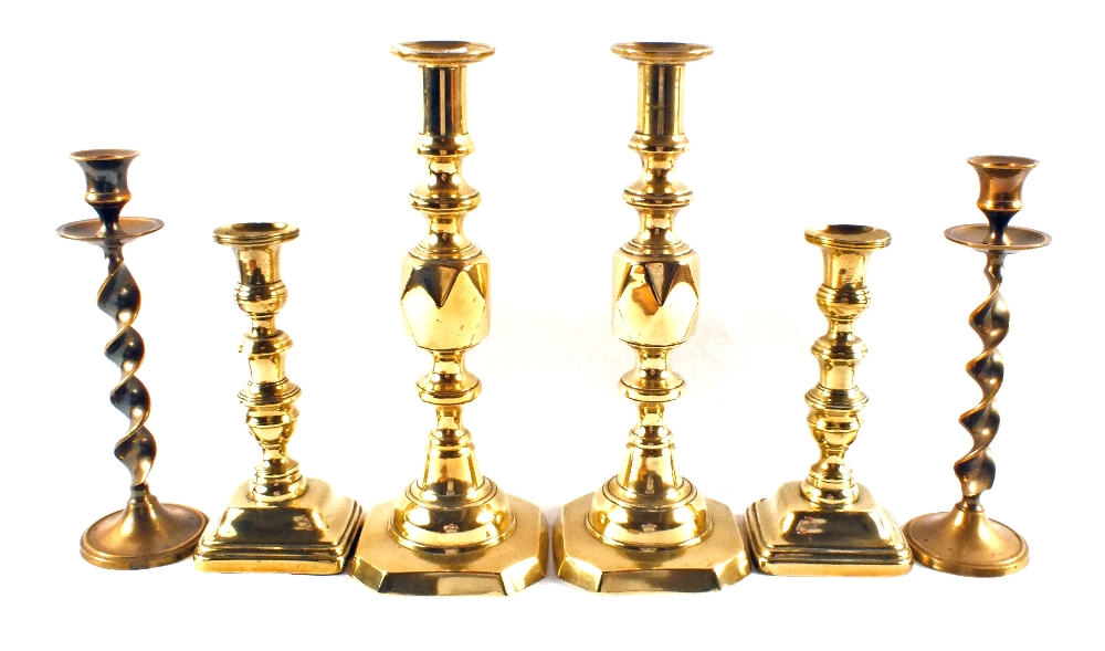 Two pairs of Victorian Brass candlesticks and one other pair