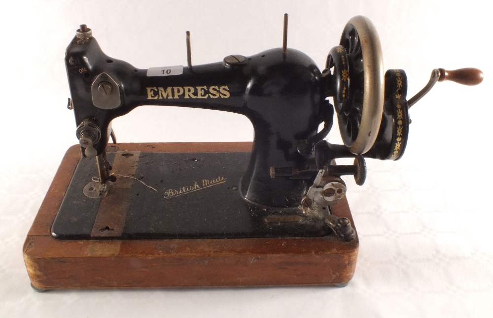 A Copper hanging oil lamp and an Empress sewing machine