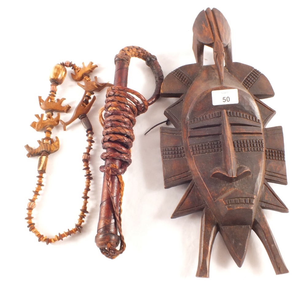 An African carved mask, whip and wood necklace