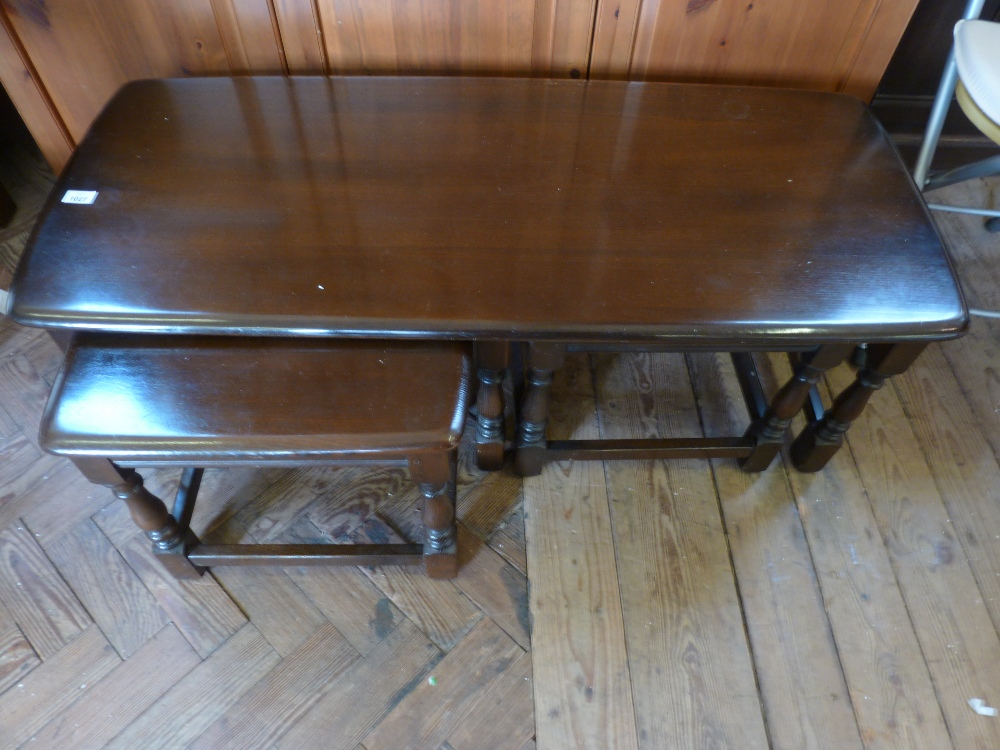 A dark Ercol three piece low coffee table