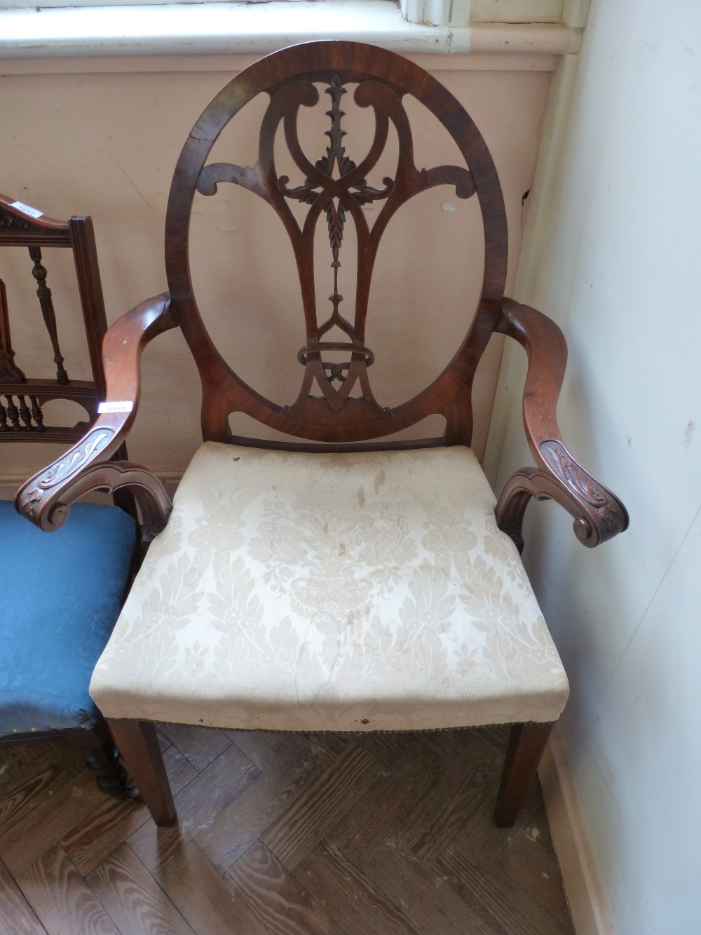 An cream upholstered Mahogany armchair