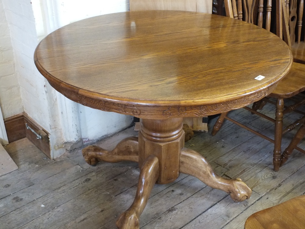 A circular Oak tripod extending breakfast table