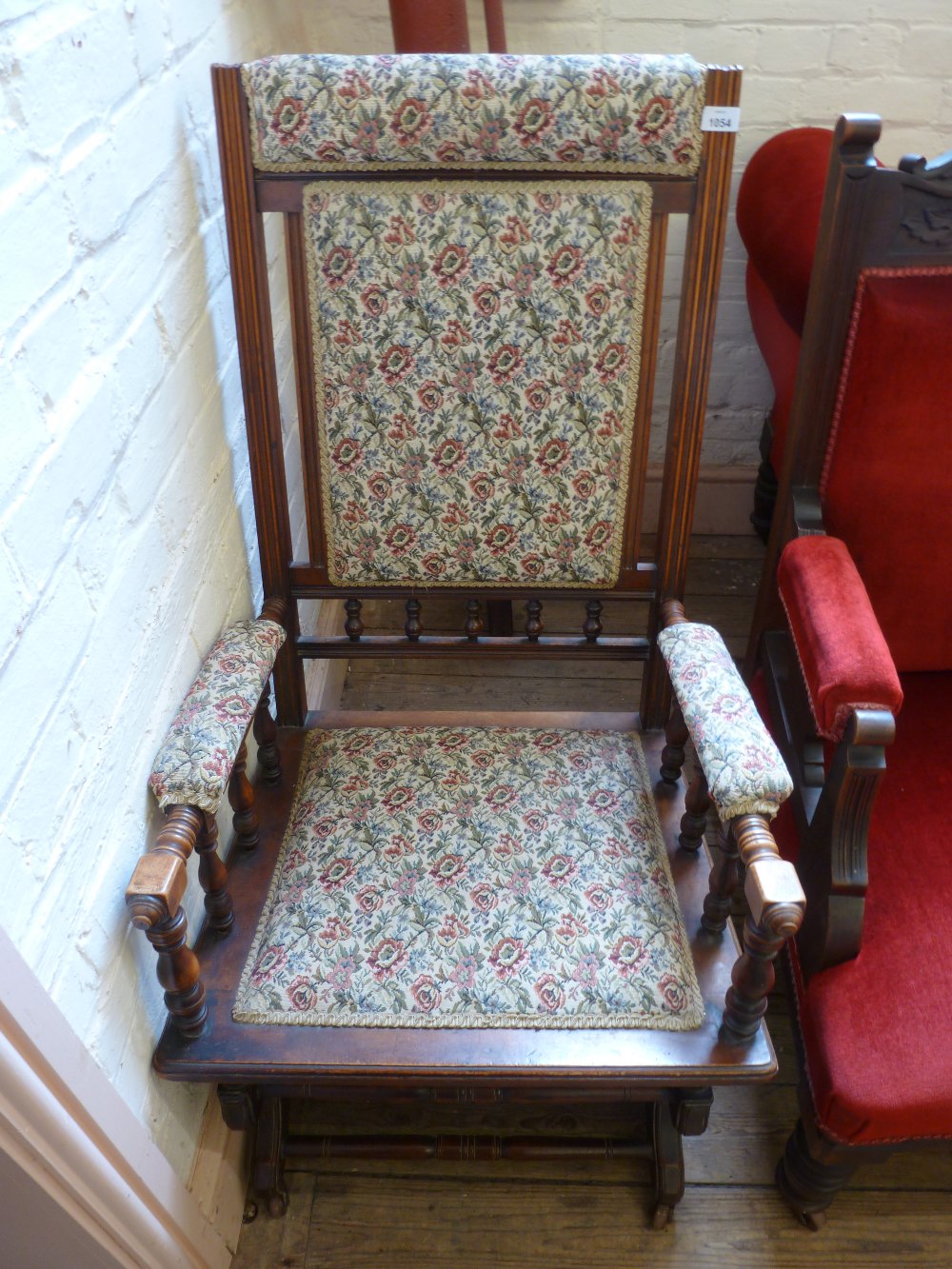 An Edwardian American Walnut upholstered spring rocking chair