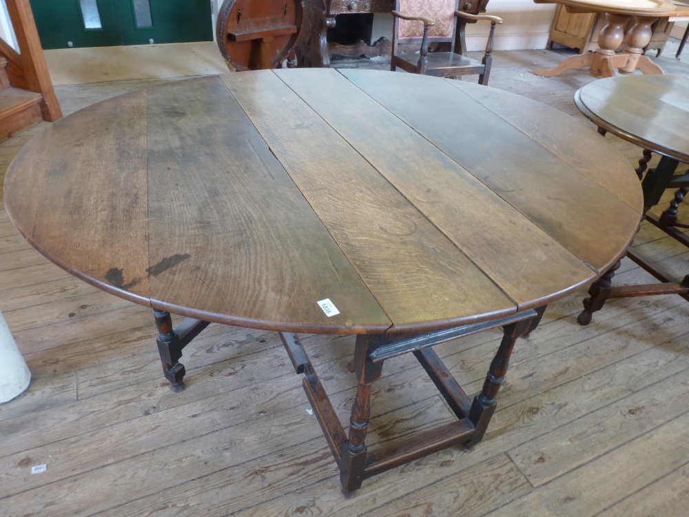 A 19th Century Oak gate leg table on turned supports