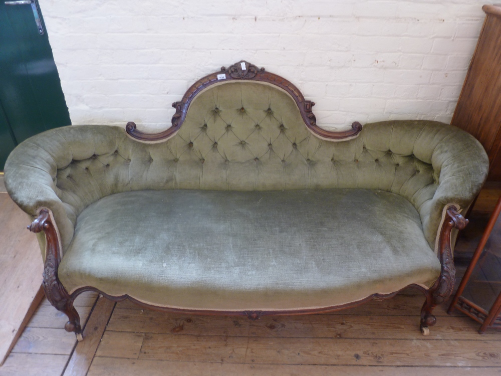 A Victorian green button back sofa