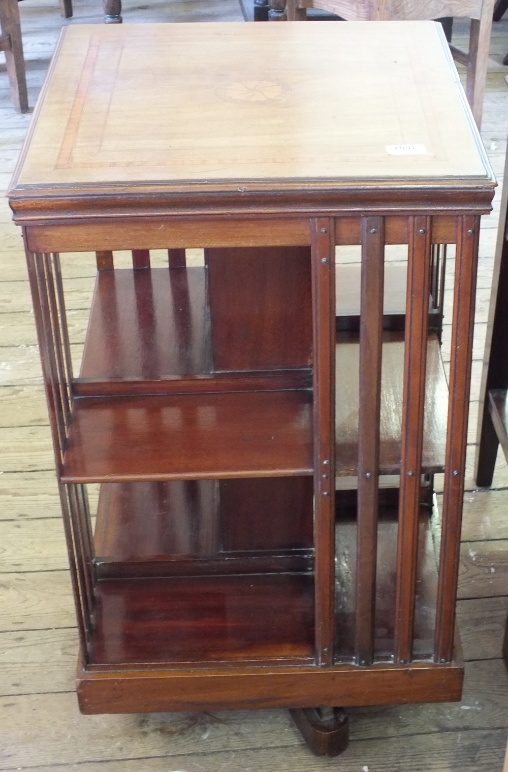 An Edwardian inlaid revolving bookcase