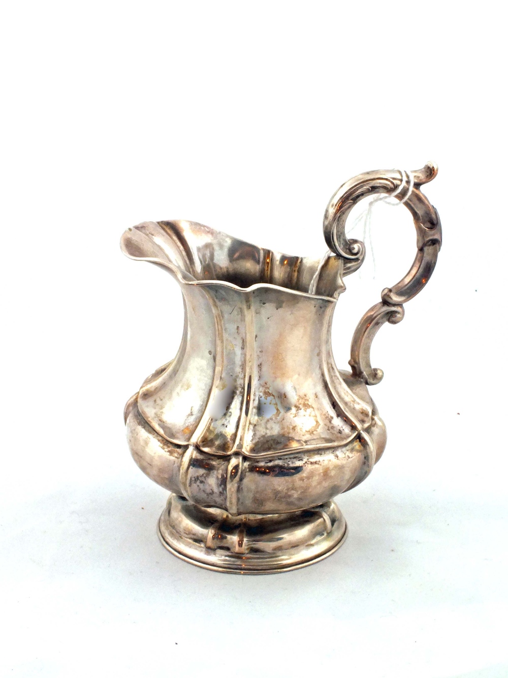 A Georgian Silver metal cream jug marked 12 (no Hallmarks visible)