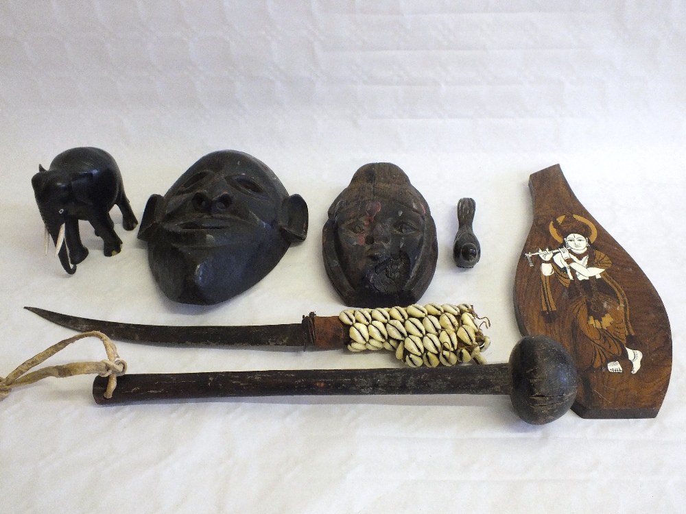 A box of ethnic masks, dagger etc