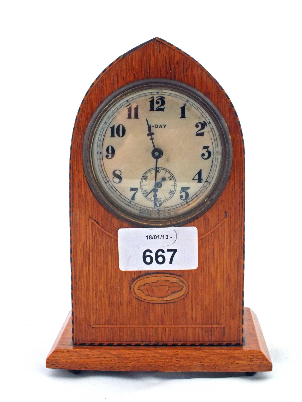 A small inlaid Oak eight day mantel clock