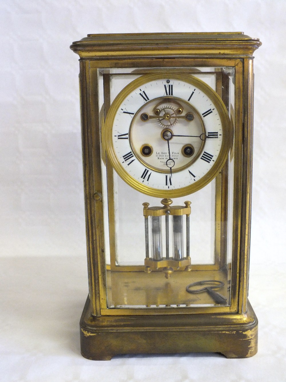 A Brass and glass cased clock by Leroy et Fils