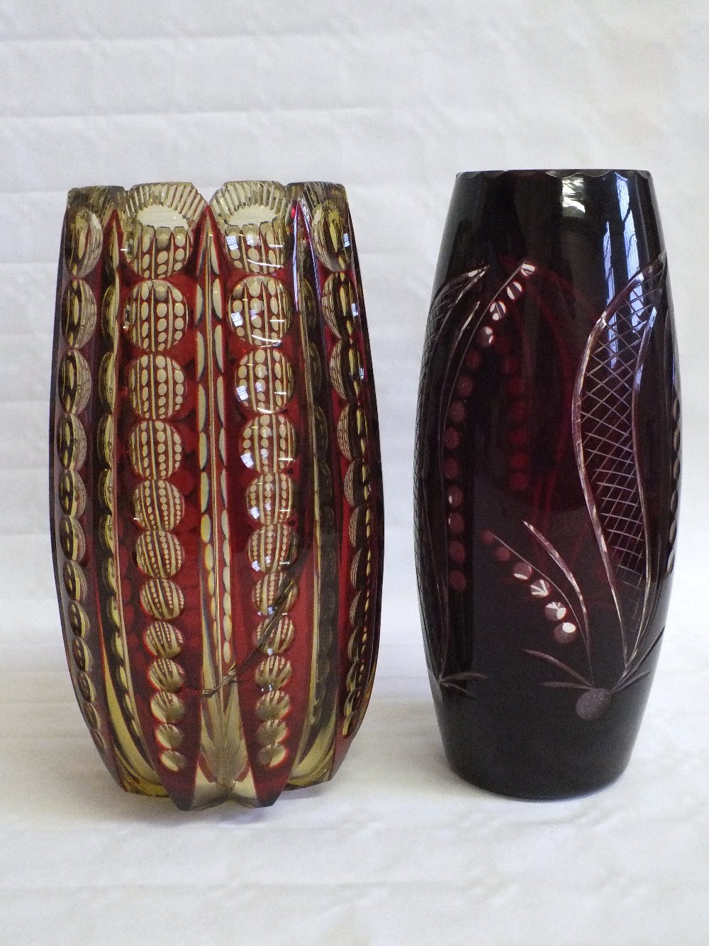 Two red overlaid cut glass vases