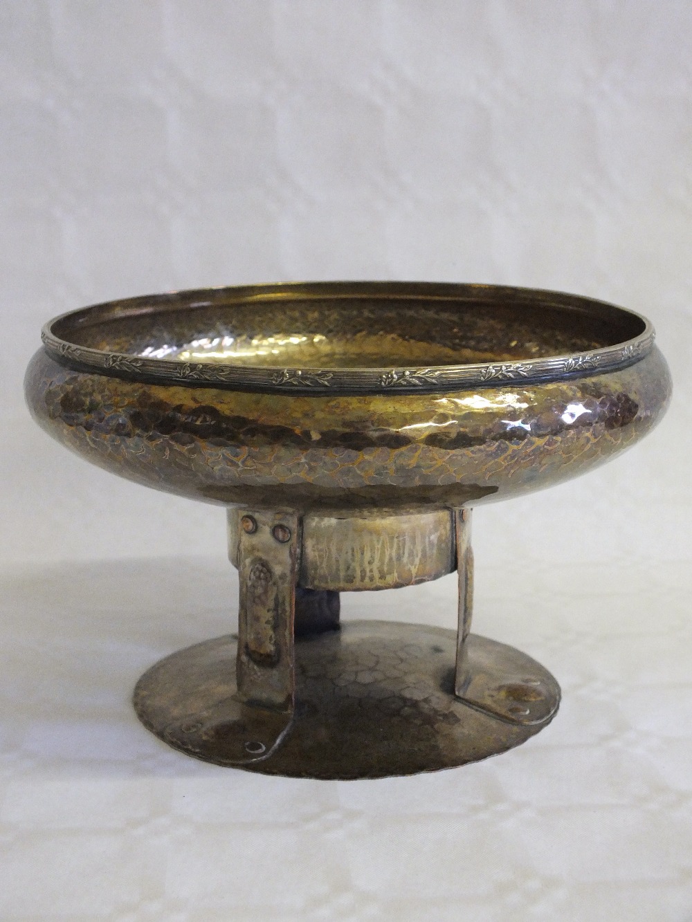 An Arts and Crafts hammered silver plated fruit bowl