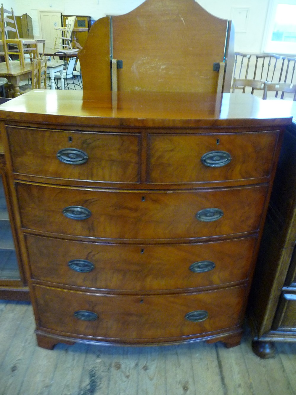 A Mahogany bow fronted chest of two short and three long drawers
