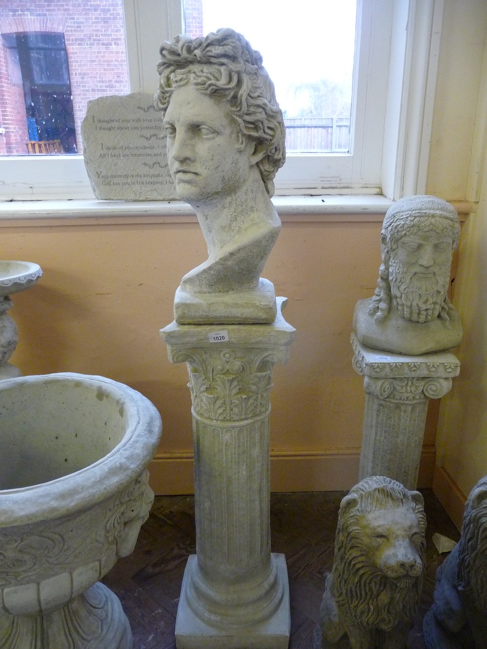 A concrete column and bust of Apollo