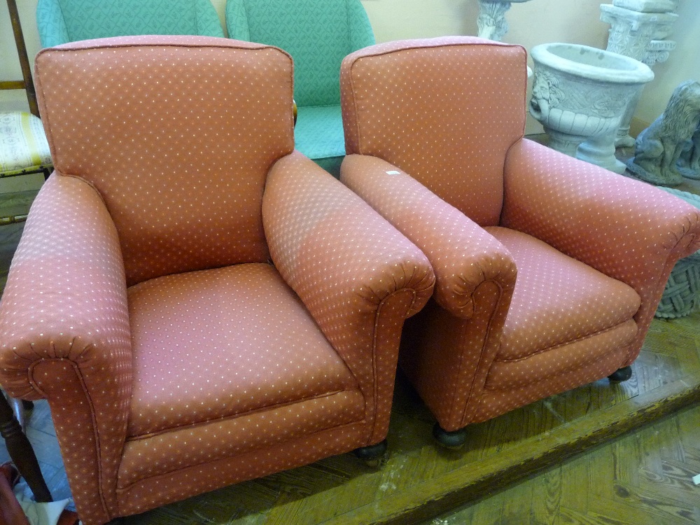 Two pink upholstered armchairs