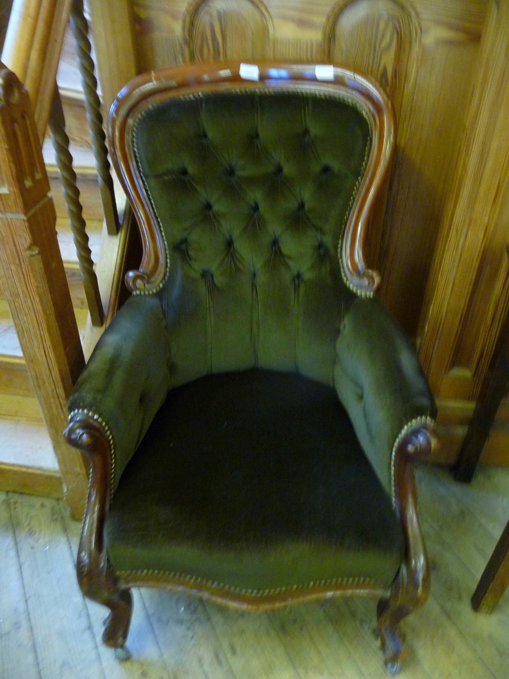 A Victorian Mahogany green upholstered button back armchair