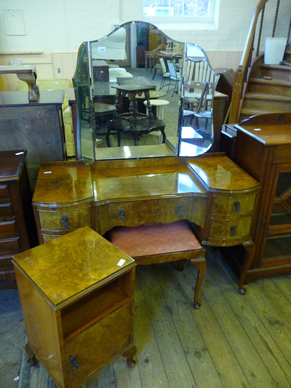 A Walnut veneered dressing table with stool and bedside table