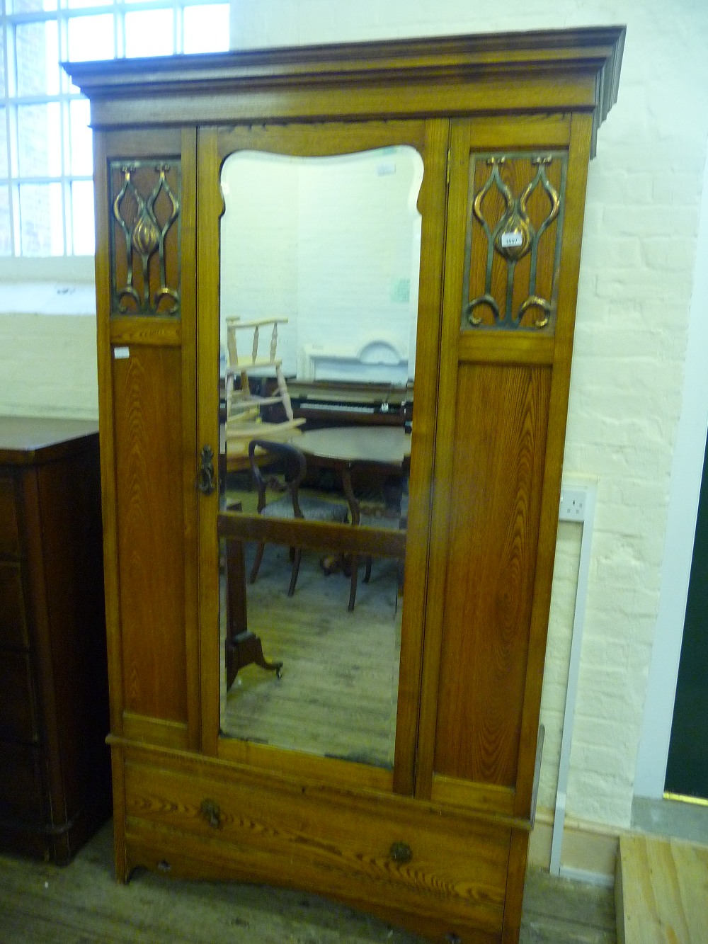 An Oak Art Nouveau style wardrobe with single mirrored door