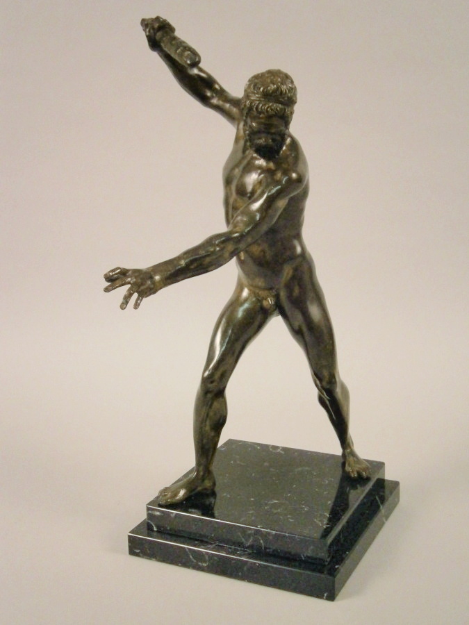 After The Antique. A bronze figure of Hercules holding a club, on a black marble base, 42cm high