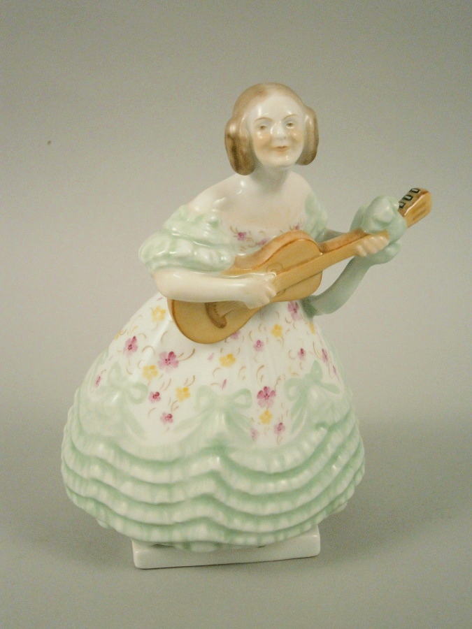 A Herend porcelain figure of a lady wearing a ballgown and playing guitar, printed mark in blue