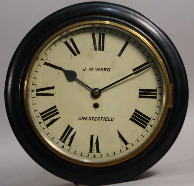 A late 19th/early 20thC ebonised and oak station type clock, the painted dial bearing the name J M
