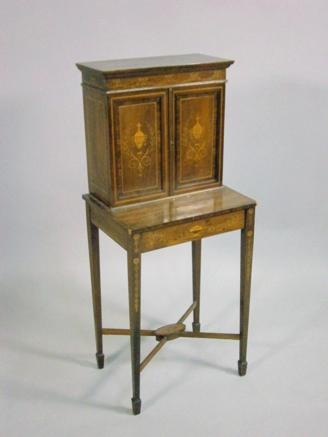 A late 19thC Sheraton Revival mahogany and marquetry side cabinet, the top with two panel doors