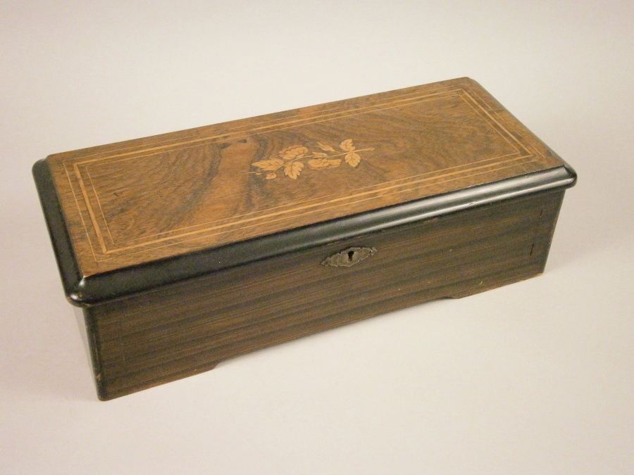 A 19thC Swiss musical box, with a 28cm brass cylinder, playing six airs, in a rosewood and marquetry