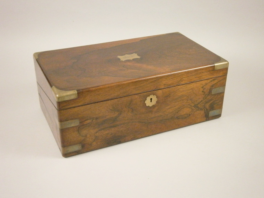 A mid 19thC rosewood and brass bound campaign type writing box, with inset side handles, a felt