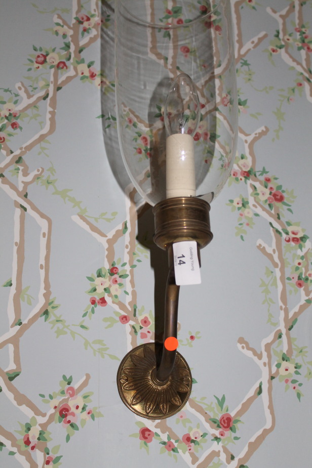 A set of three gilt metal wall lights, with glass shades, 43cm high overall.