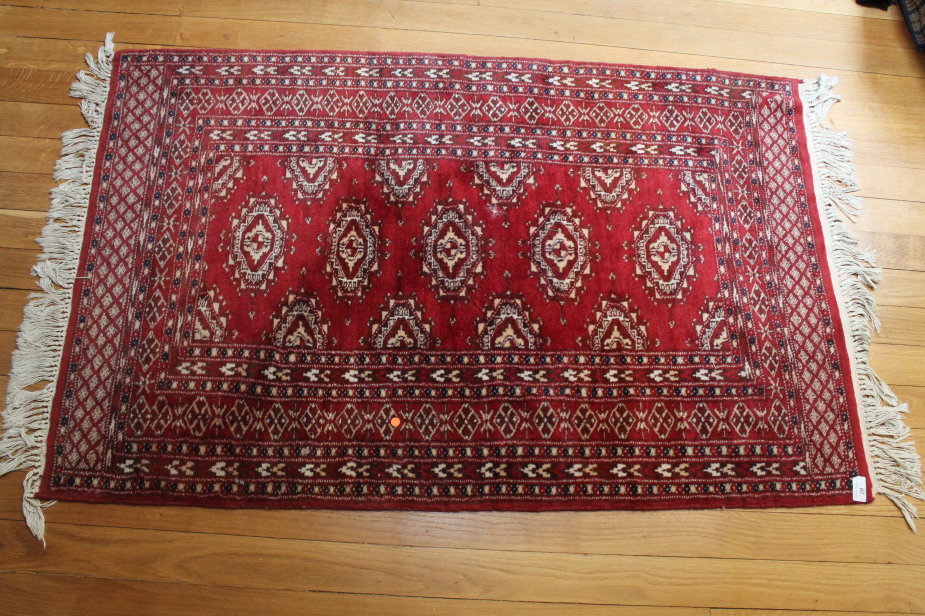 A Bokhara type red ground rug, 126cm x 80cm.