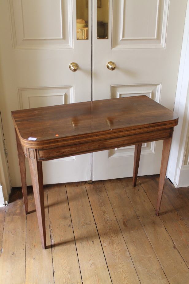 A Regency rosewood card table, with rounded rectangular folding top, with baize interior and