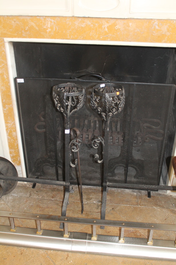 A pair of wrought iron andirons with basket tops, 56cm deep, 80cm high.