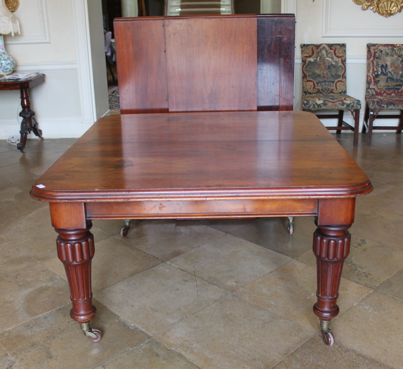 A Victorian mahogany wind-out extending dining table, with moulded border, raised on reeded supports