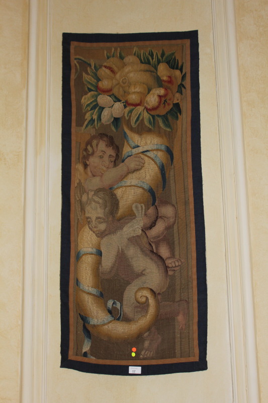 A pair of 18thC tapestry panels, depicting cherubs within cornucopia, 110cm x 47cm.