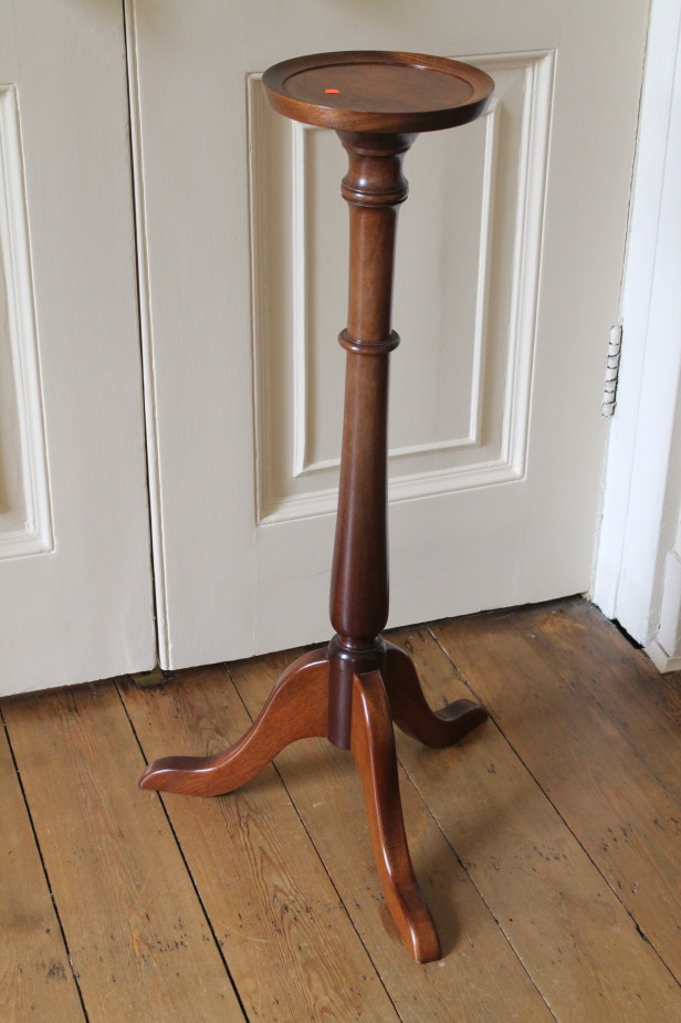 A mahogany torchere in the Georgian manner.