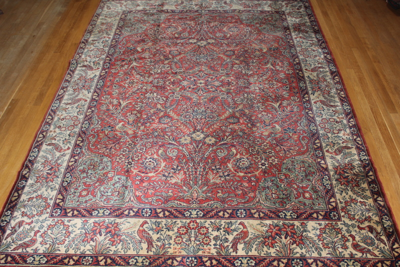 A Persian style bordered carpet and a small modern rug, (2)