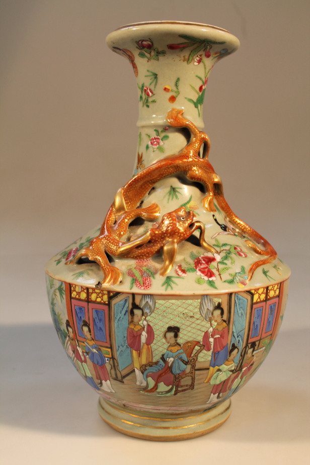 A Chinese late 19thC Canton dragon vase, decorated in polychrome enamels with courtesans,