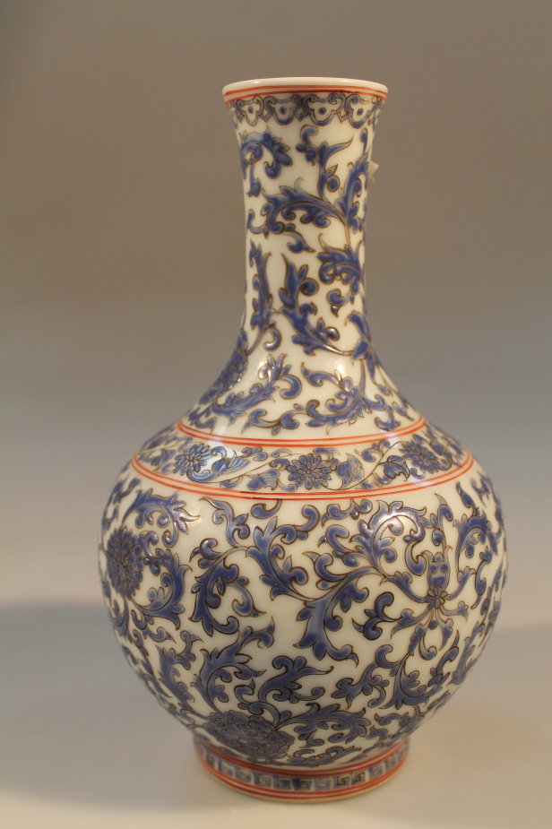 A Chinese export bottle vase, decorated with floral scrolls and chrysanthemums and seal mark to