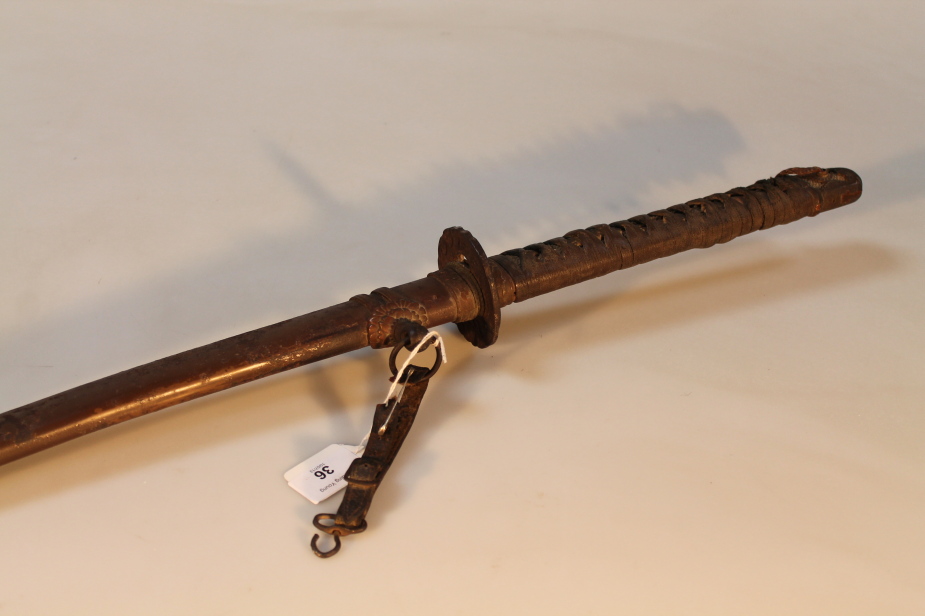 A 20thC Japanese kutana, with tsuba moulded with dragon motif, with metal scabbard, blade 66cm long,