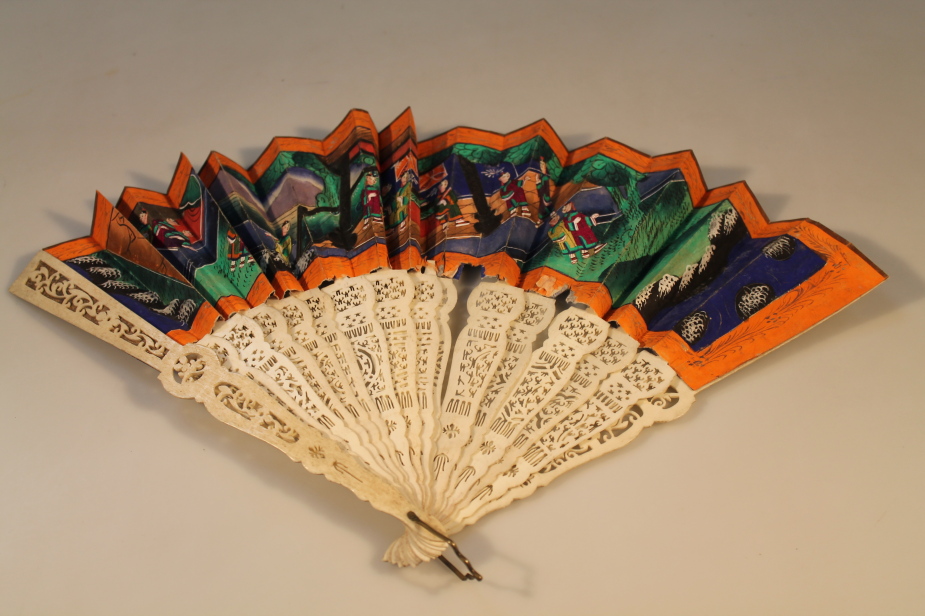 A Chinese early 20thC carved bone fan, decorated with Chinese interior scenes, (AF), 28cm long.