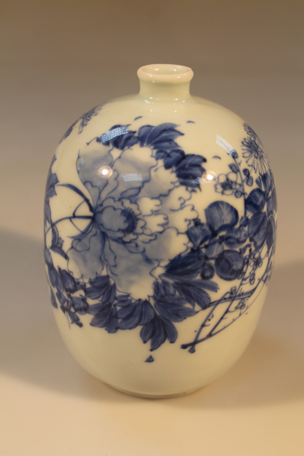 A Japanese small meiping Style vase, decorated in underglaze blue with stylized flowers, 15cm high.